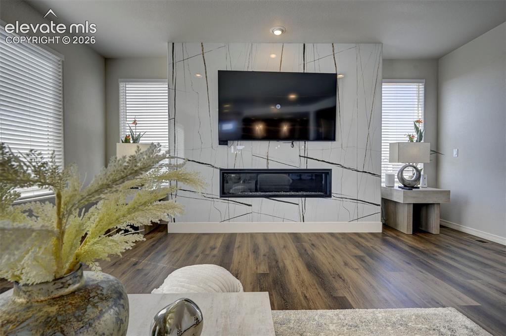 Image 12 of 45: Feature wall with an integrated linear electric fireplace, recessed lightin