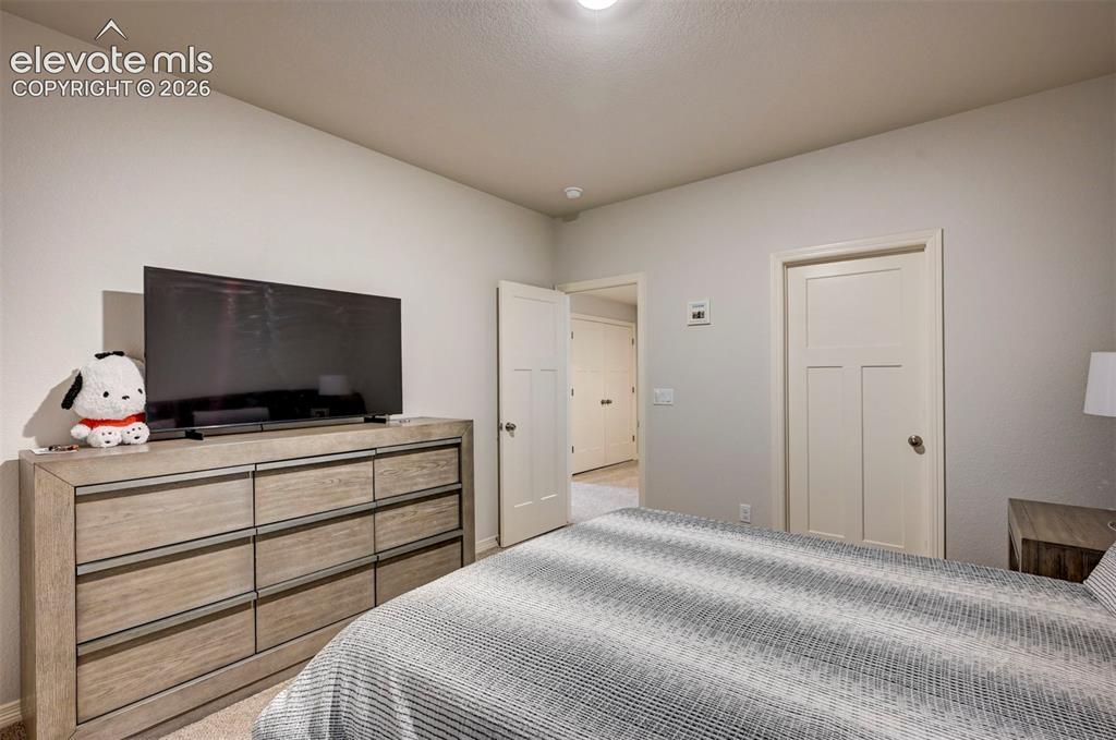 Image 38 of 45: Bedroom featuring neutral wall paint, white trim, and a ceiling light fixtu