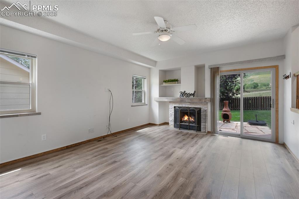 Image 12 of 50: LVP, gas fireplace