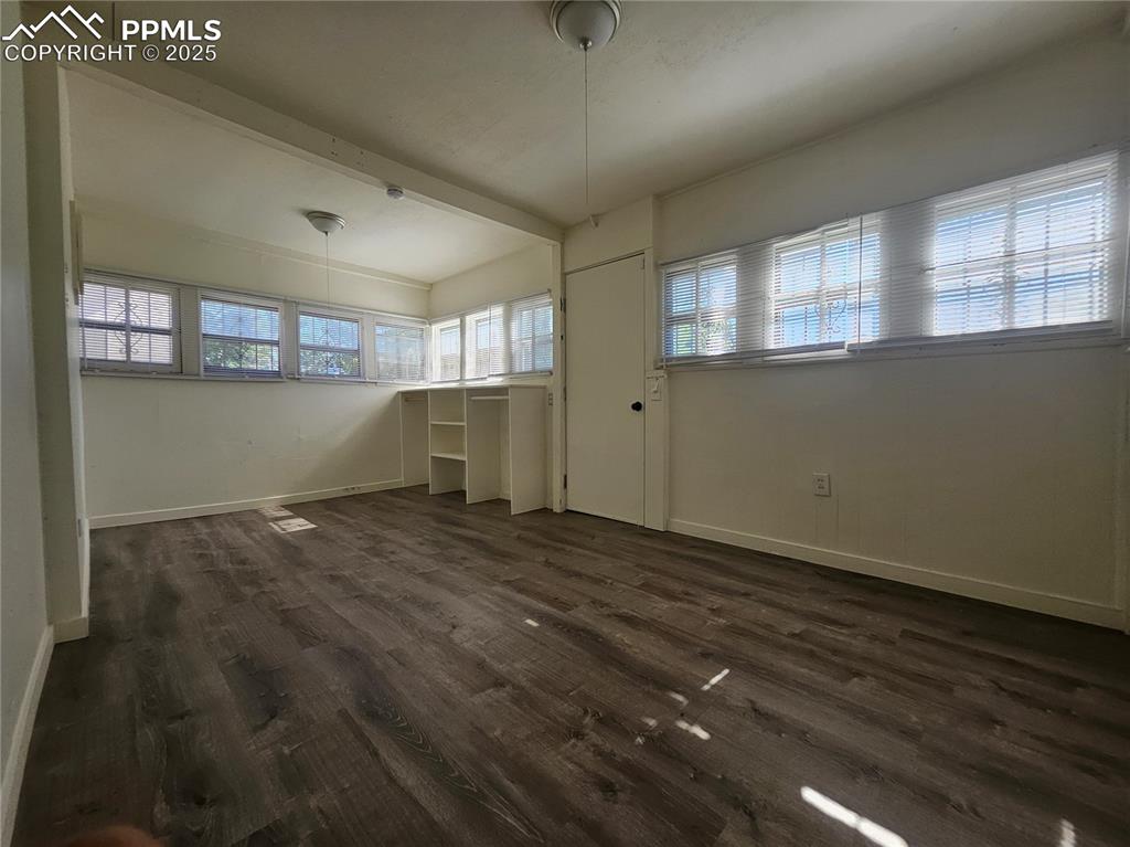 Image 20 of 23: Unfurnished dining area featuring dark wood-style floors
