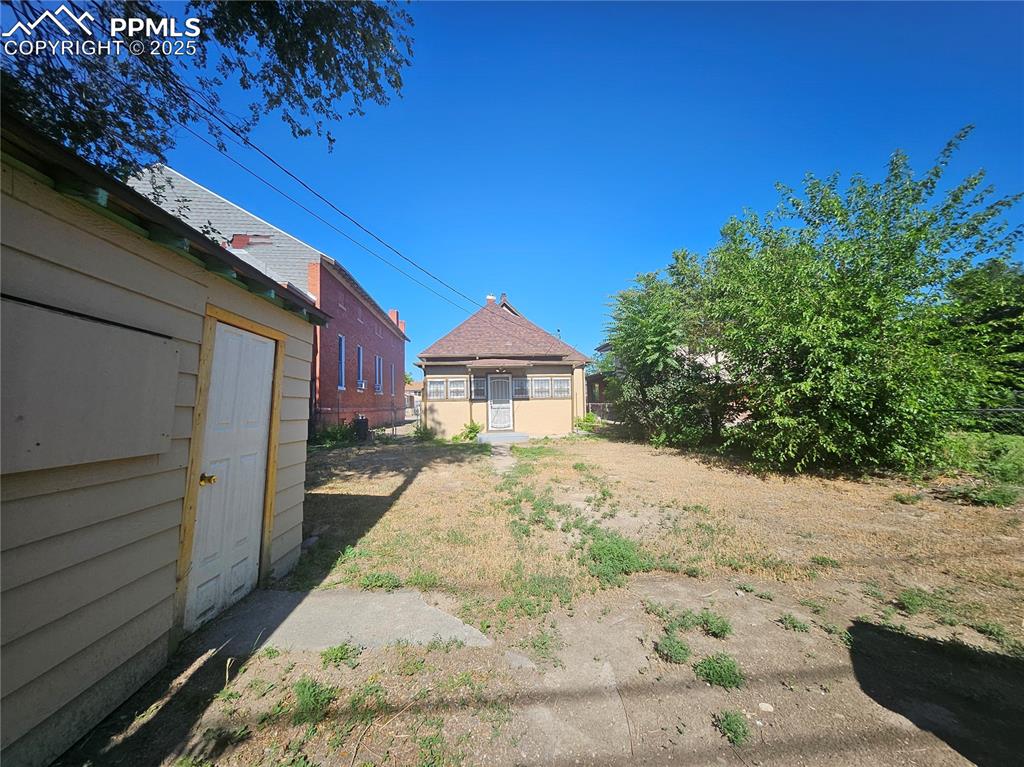 Image 23 of 23: View of yard featuring an outbuilding