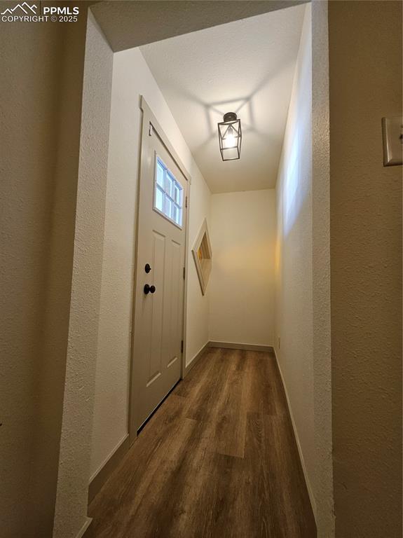 Image 4 of 23: Entryway with wood finished floors and a textured wall