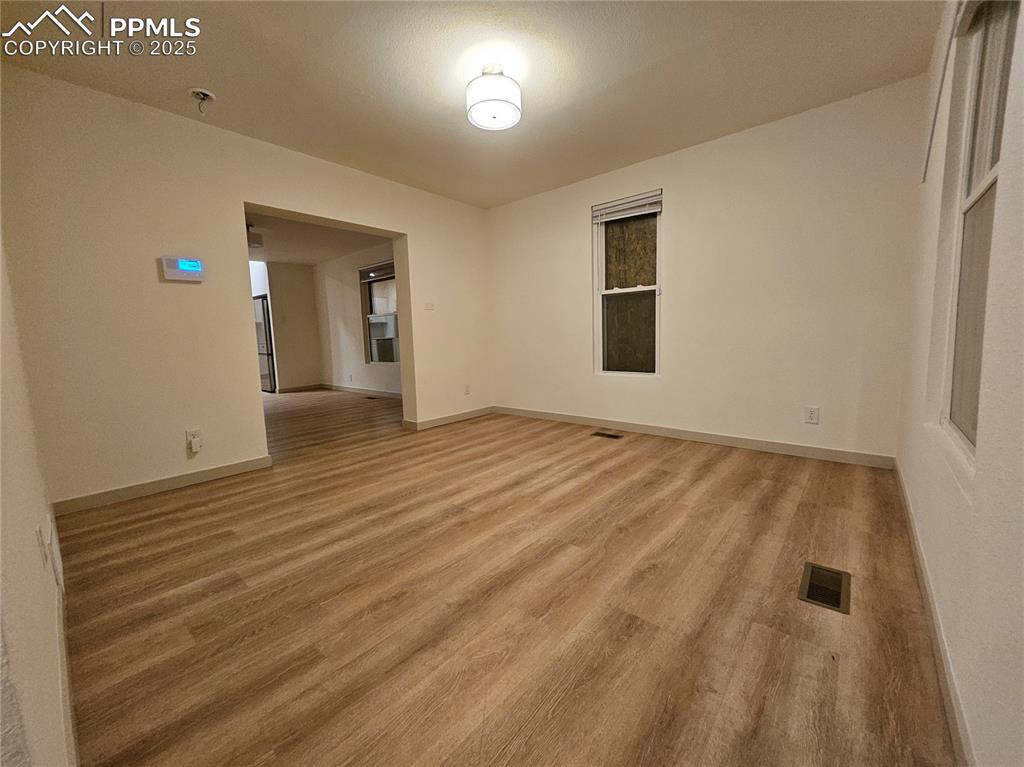 Image 5 of 23: Spare room featuring light wood finished floors and baseboards