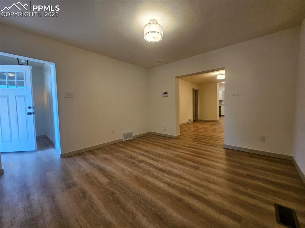 Image 6 of 23: Empty room with wood finished floors