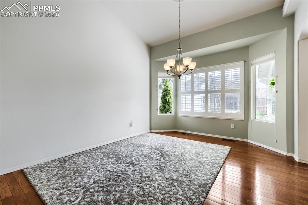 Image 10 of 31: The kitchen offers quartz countertops, a breakfast bar, crown-molded cabine