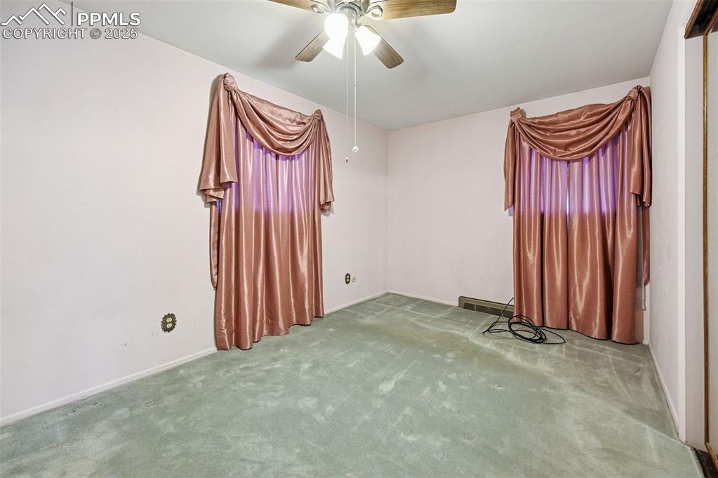 Image 12 of 23: Empty room with carpet and ceiling fan