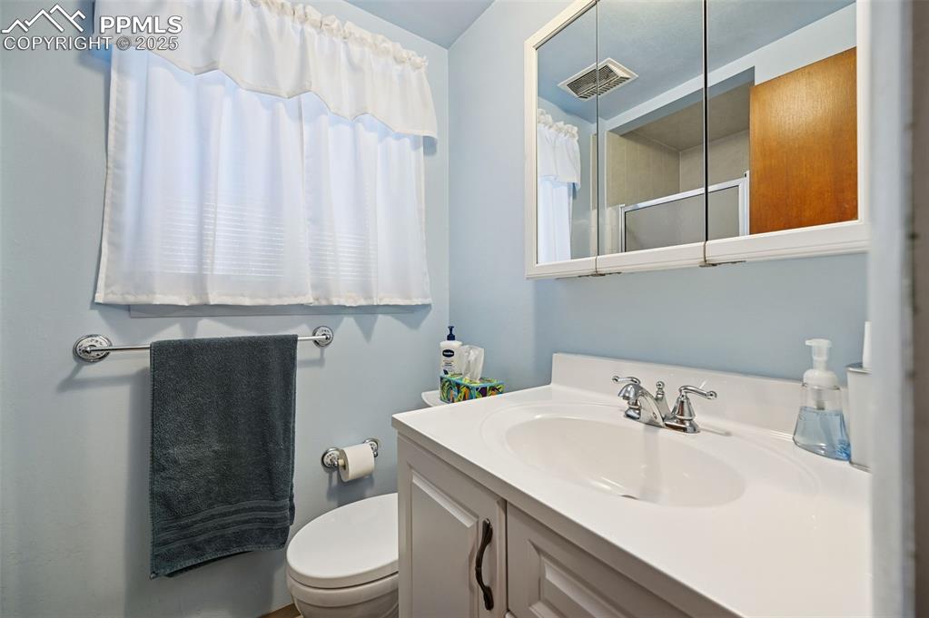 Image 14 of 23: Full bathroom featuring vanity and an enclosed shower