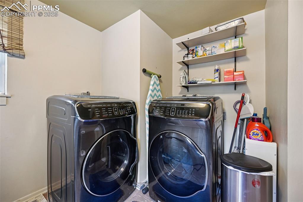 Image 18 of 23: Laundry area featuring washing machine and clothes dryer
