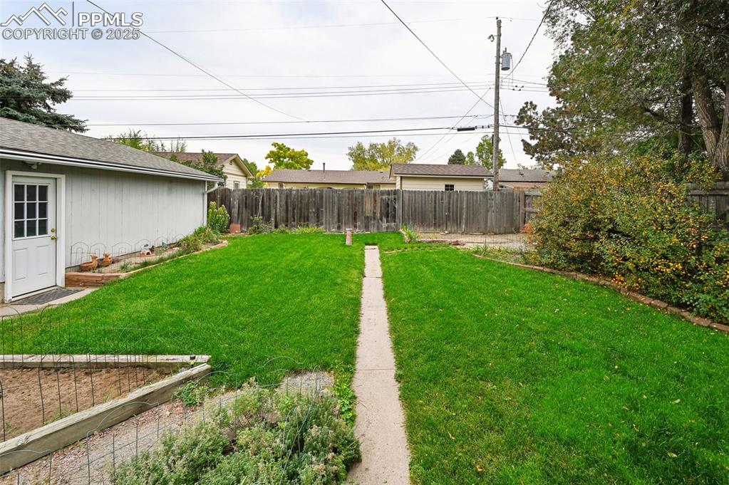 Image 19 of 23: View of fenced backyard