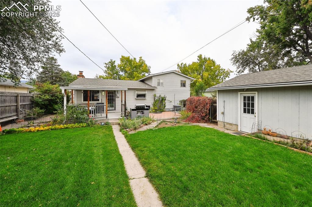 Image 20 of 23: Back of property with a shingled roof