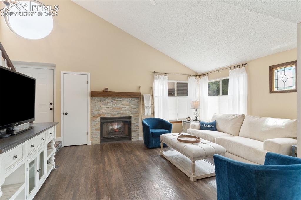 Image 11 of 34: Living room featuring plenty of natural light, dark wood finished floors, a