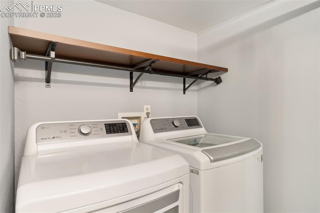 Image 29 of 34: Washroom featuring washer and clothes dryer