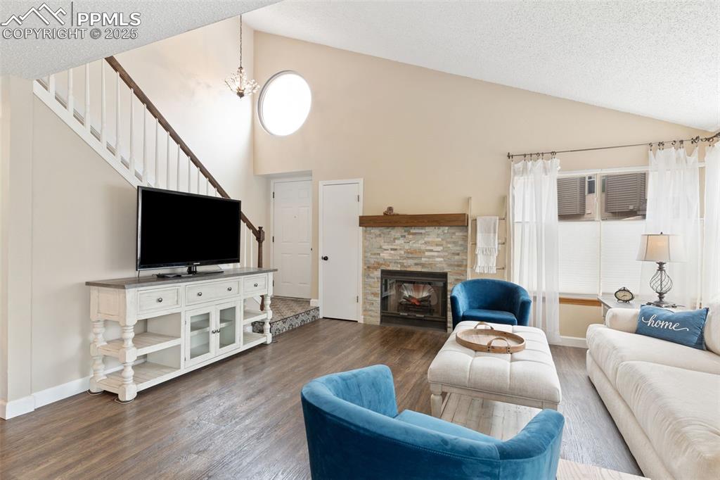 Image 9 of 34: Living area featuring a textured ceiling, healthy amount of natural light,
