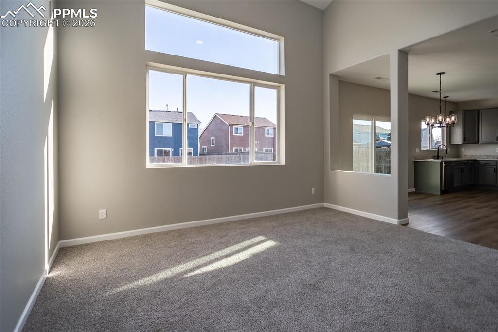 Image 10 of 42: The living room is open to the kitchen and dining area.