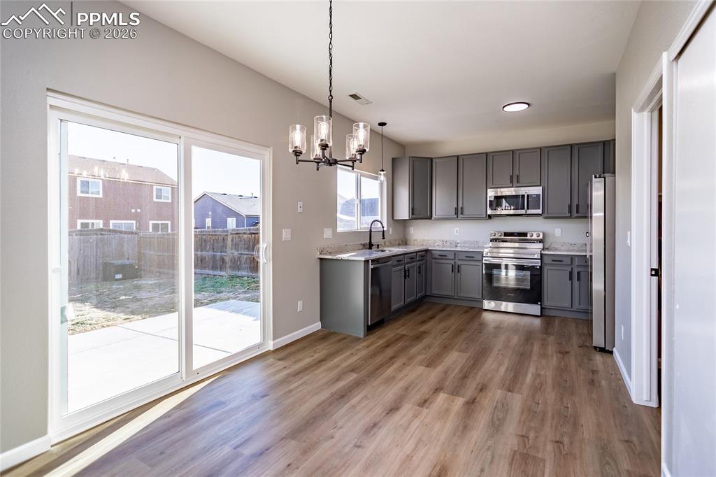 Image 14 of 42: Open kitchen with lovely granite and gleaming new appliance, huge sink over