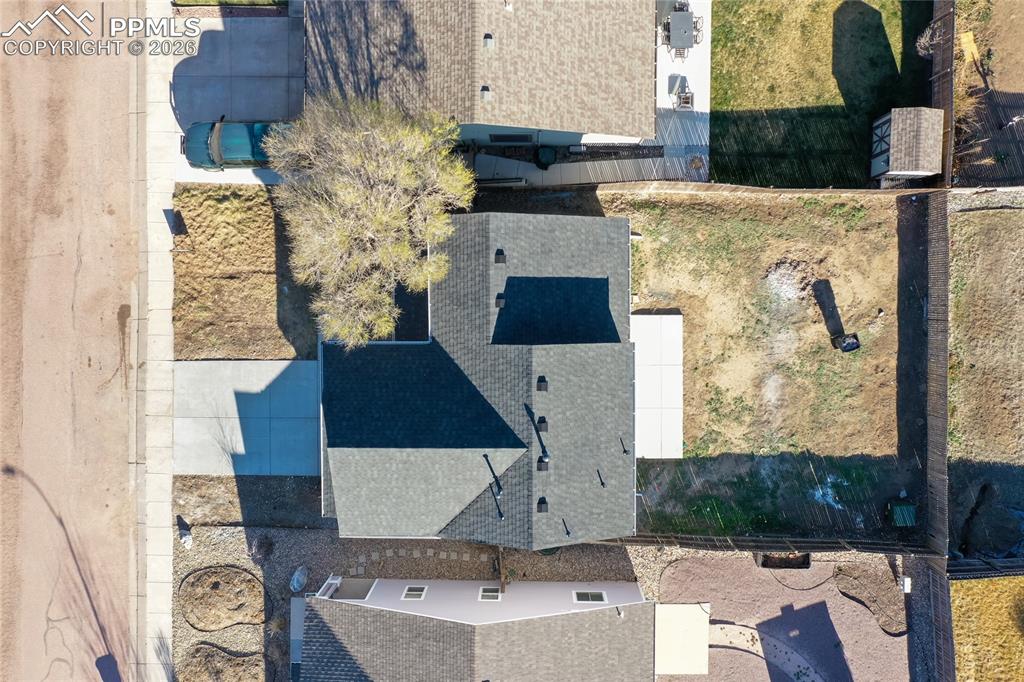 Image 36 of 42: Shows the new roof, new driveway, new patio and large fenced.