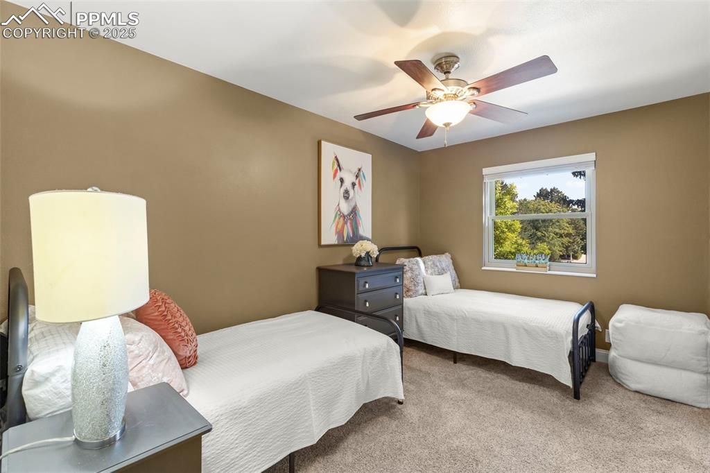 Image 20 of 46: Carpeted bedroom featuring a ceiling fan and baseboards