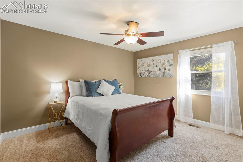 Image 21 of 46: Carpeted bedroom featuring baseboards and a ceiling fan