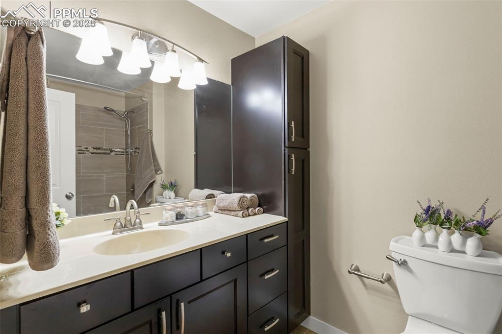 Image 23 of 46: Full bathroom with vanity and tiled shower