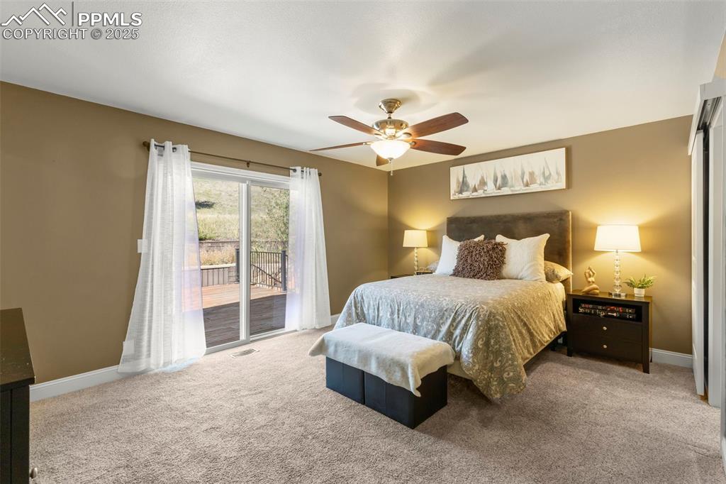 Image 24 of 46: Carpeted bedroom featuring access to exterior and a ceiling fan