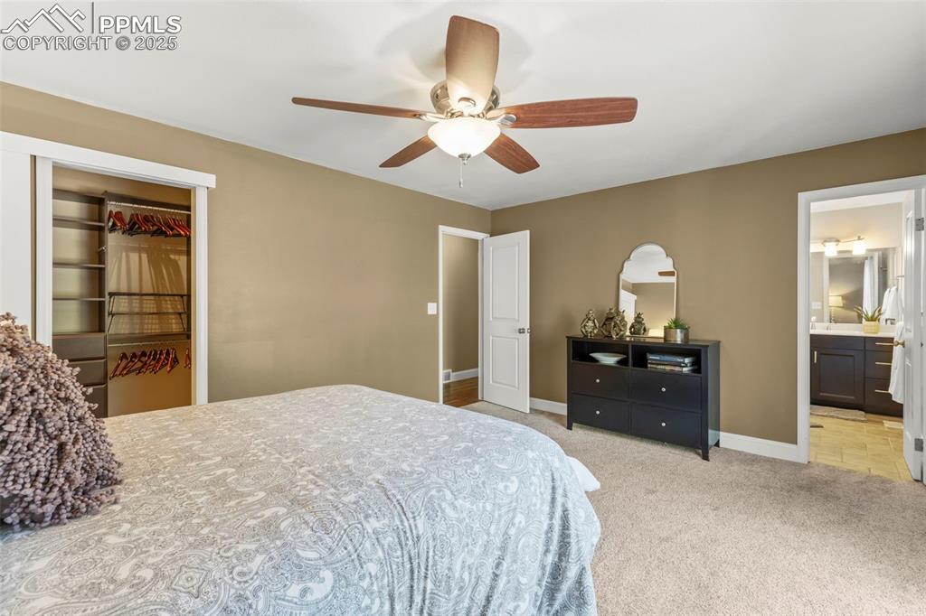 Image 26 of 46: Bedroom featuring light colored carpet, a closet, ceiling fan, and connecte