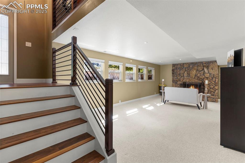 Image 28 of 46: Bedroom with carpet and a fireplace