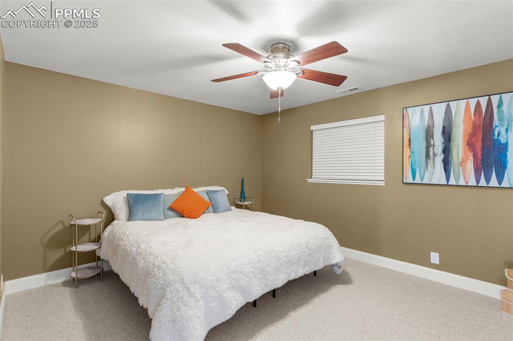 Image 33 of 46: Bedroom with carpet and a ceiling fan