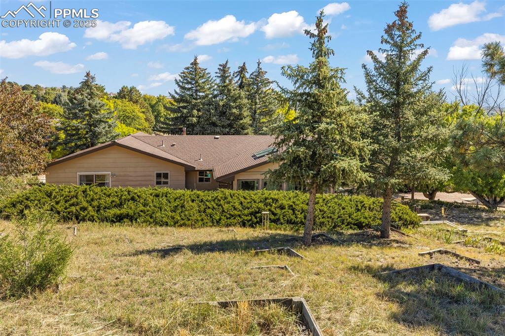 Image 41 of 46: Rear view of house featuring a garden