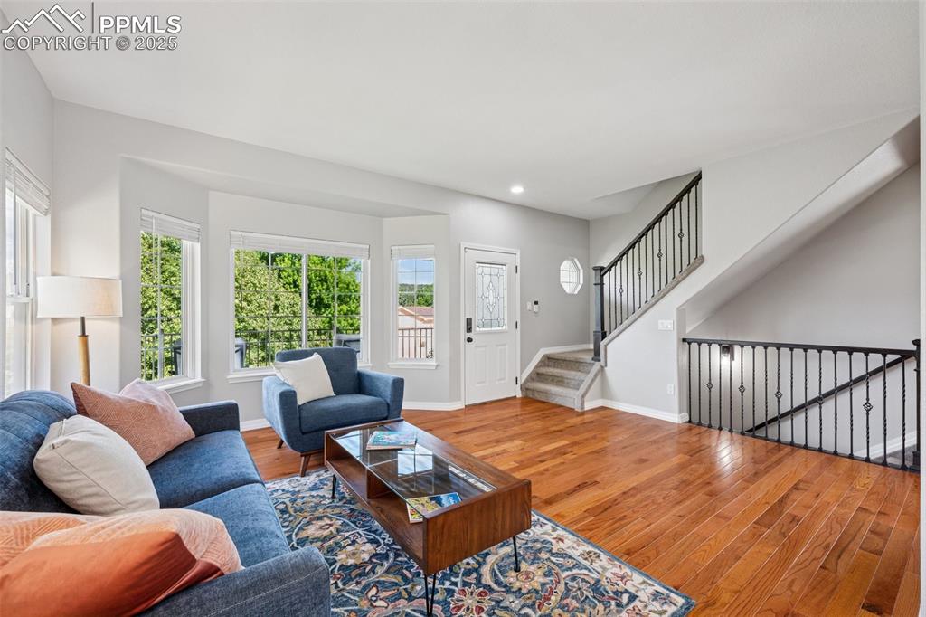 Image 18 of 50: Living area featuring wood finished floors, plenty of natural light, recess