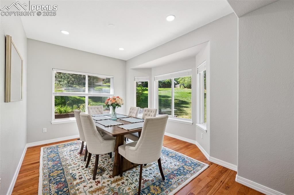 Image 20 of 50: Dining area featuring wood finished floors and recessed lighting