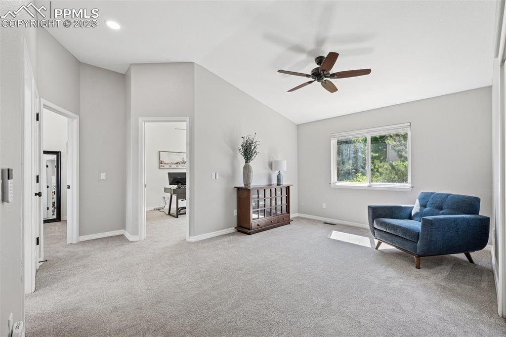 Image 22 of 50: Sitting room featuring ceiling fan, vaulted ceiling, and carpet