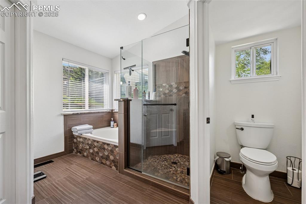 Image 29 of 50: Full bathroom featuring a garden tub, a shower stall, and recessed lighting