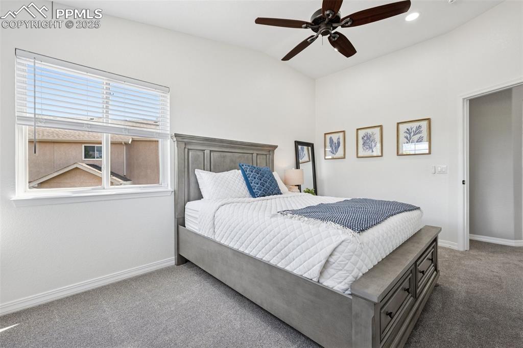 Image 33 of 50: Bedroom with carpet flooring, vaulted ceiling, a ceiling fan, and recessed