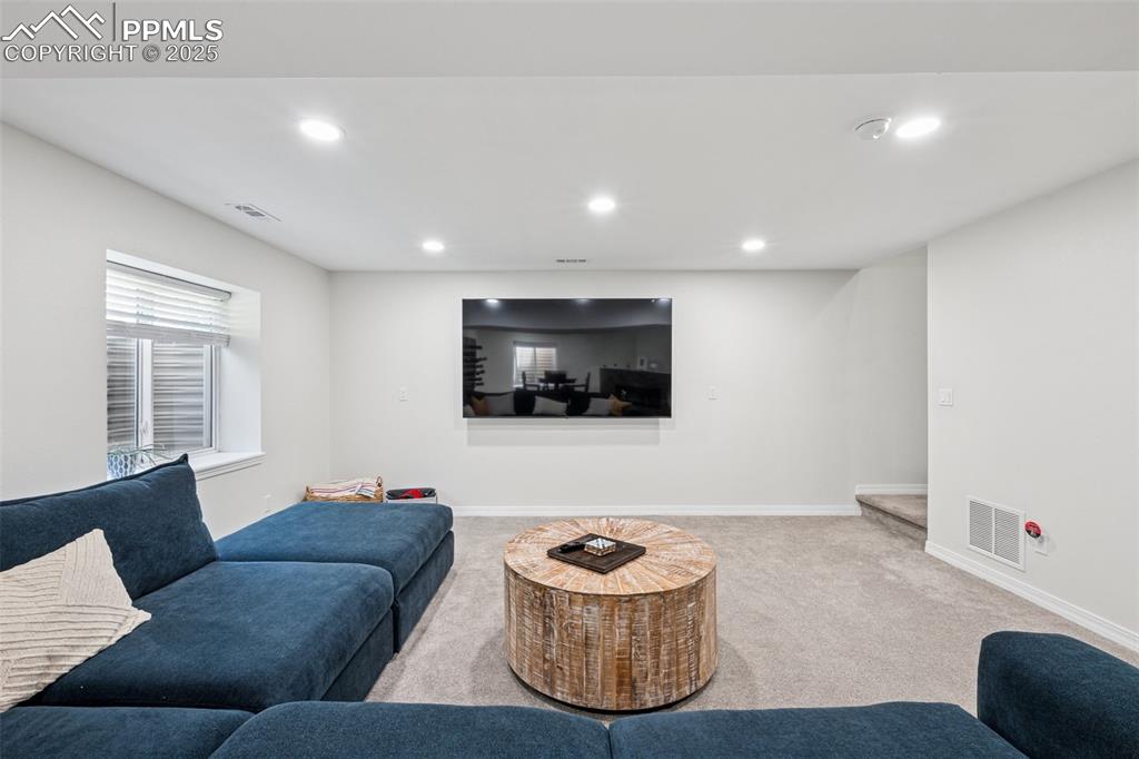 Image 38 of 50: Carpeted living area featuring recessed lighting and baseboards