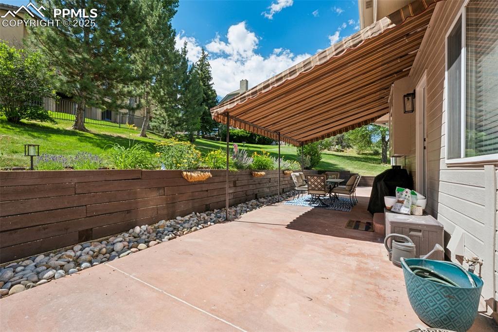 Image 4 of 50: View of patio with outdoor dining area