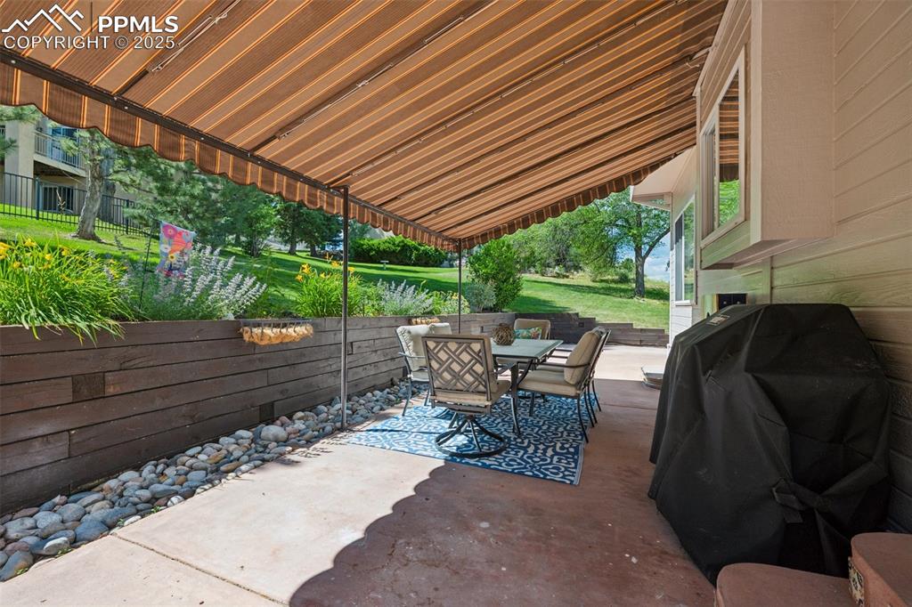 Image 5 of 50: View of patio / terrace with outdoor dining area and grilling area