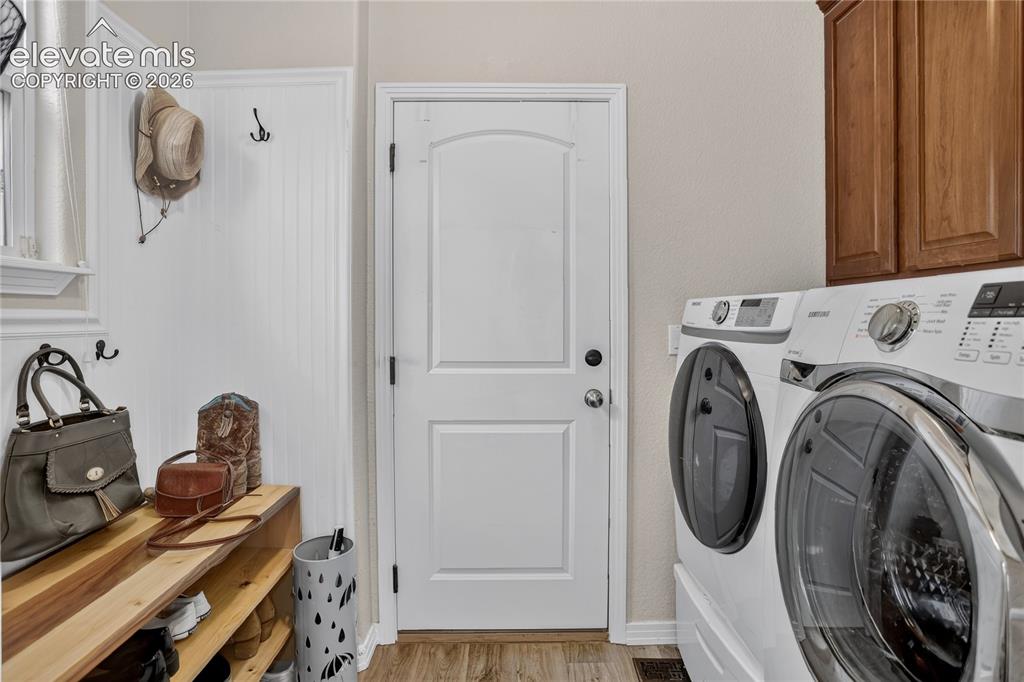 Image 11 of 26: Laundry area w/ garage access