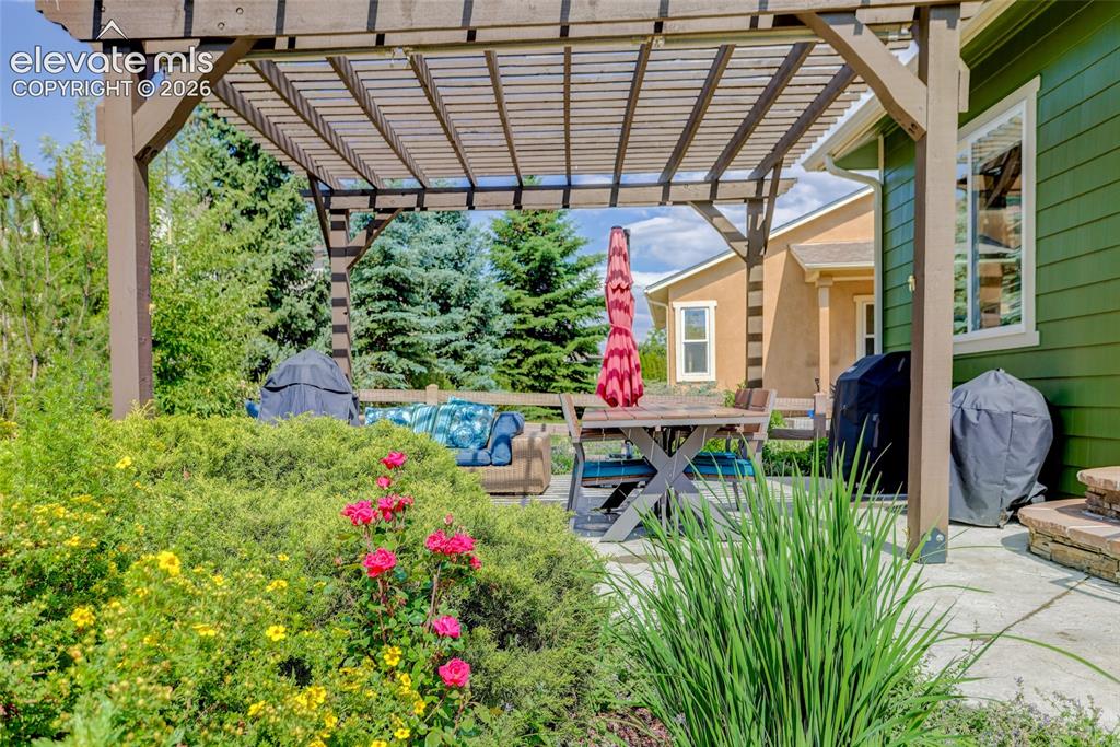 Image 23 of 26: Beautifully landscaped back patio