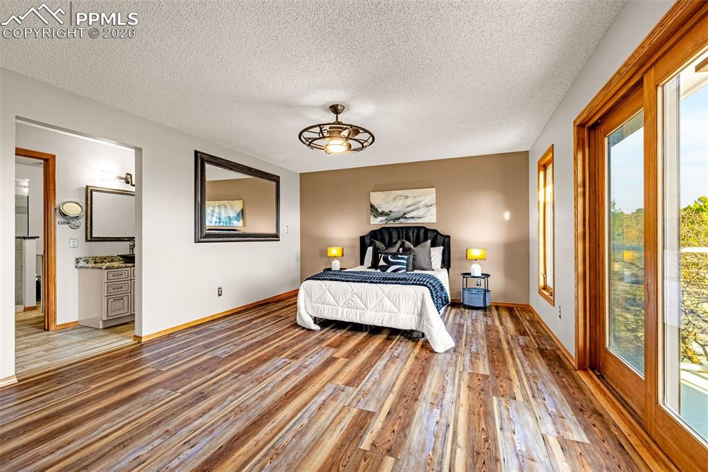 Image 21 of 39: Primary Bedrrom with ensuite bath and balcony