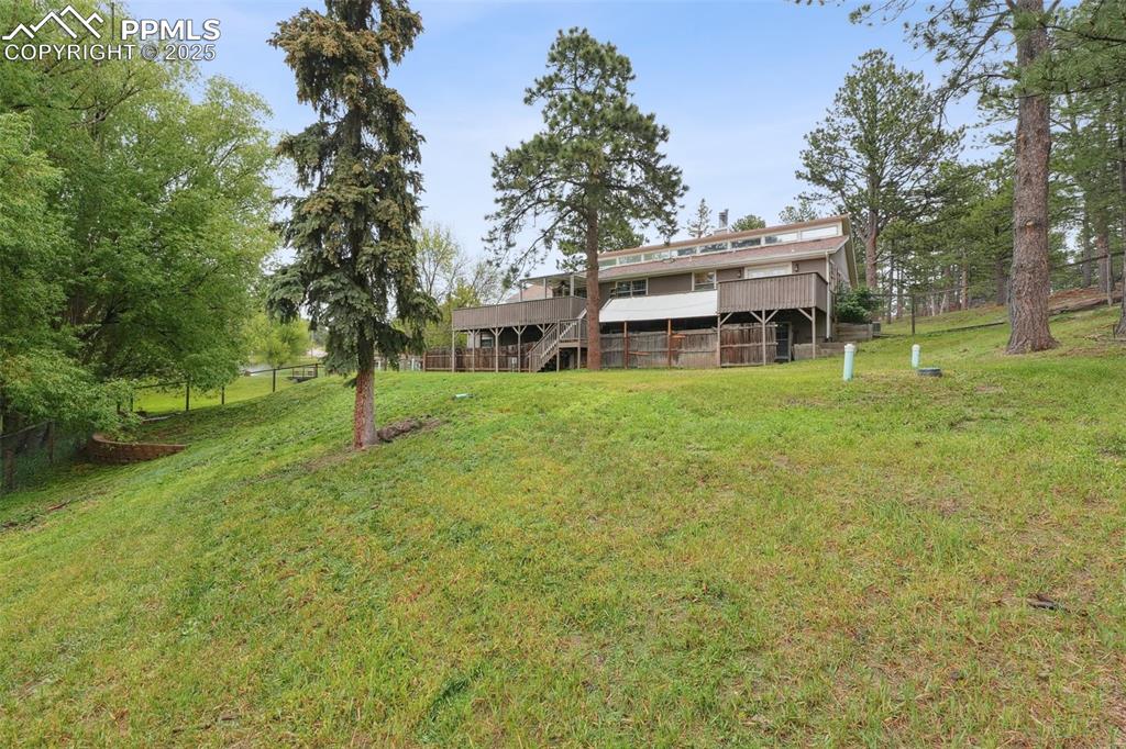 Image 32 of 38: View of yard featuring a deck and stairway