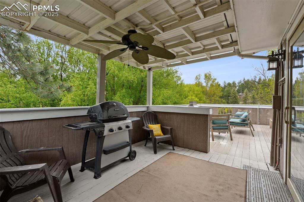Image 5 of 38: View of patio featuring a ceiling fan, grilling area, and a deck