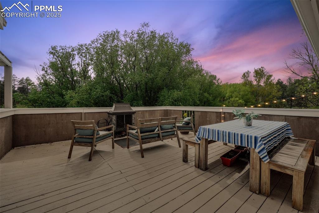 Image 8 of 38: Wooden terrace featuring an outdoor hangout area