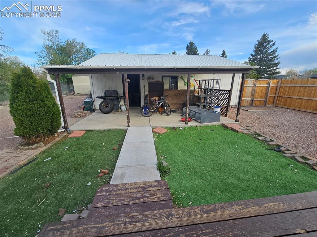 Image 27 of 28: garage with patio