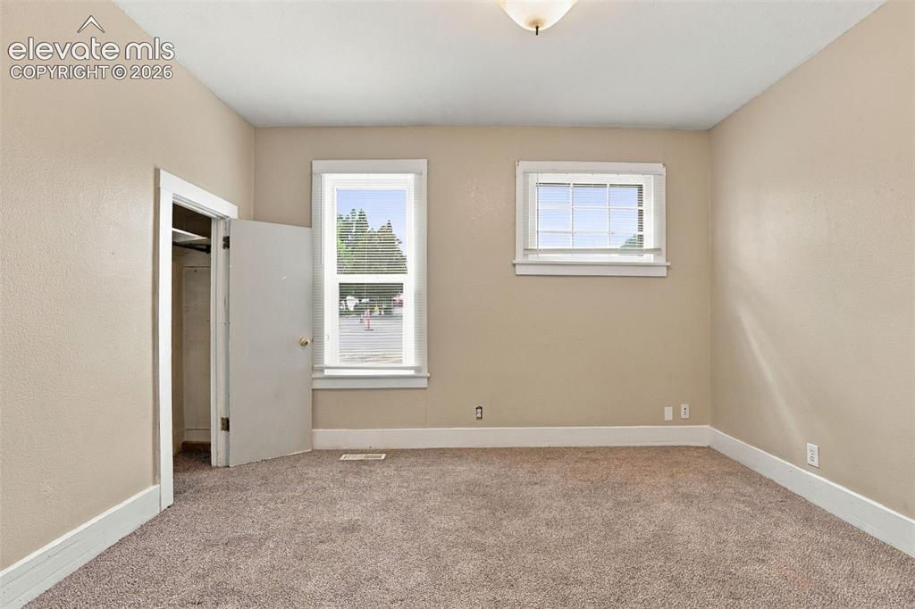Image 19 of 34: Neutral-toned walls complement plush carpeting