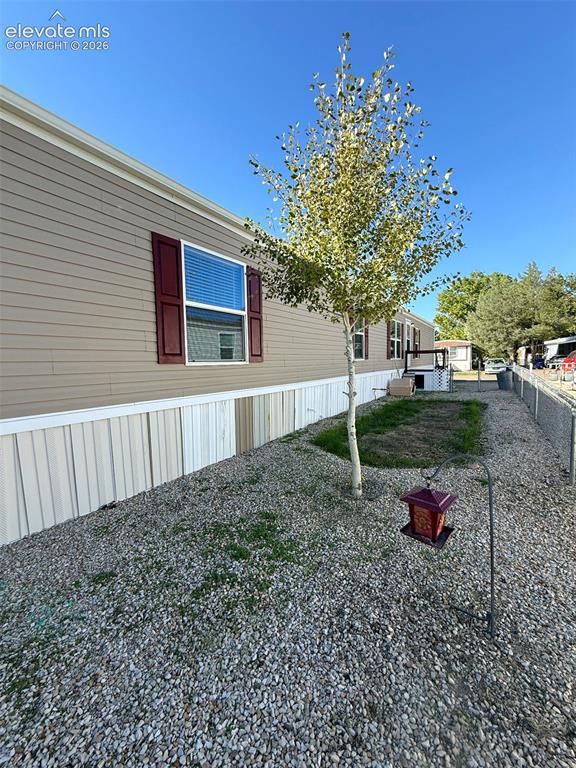 Image 5 of 28: FRONT OF HOME WITH YARD AND chain-link fencing