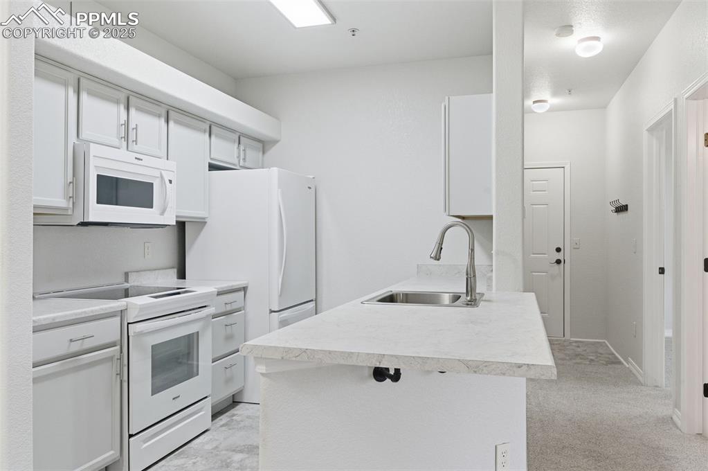 Image 10 of 39: Kitchen with white appliances