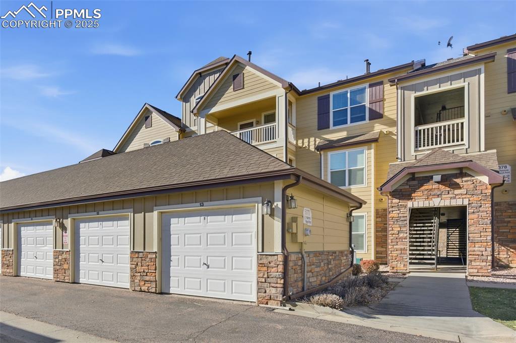 Image 35 of 39: Craftsman-style home featuring roof with shingles, stone siding, board and