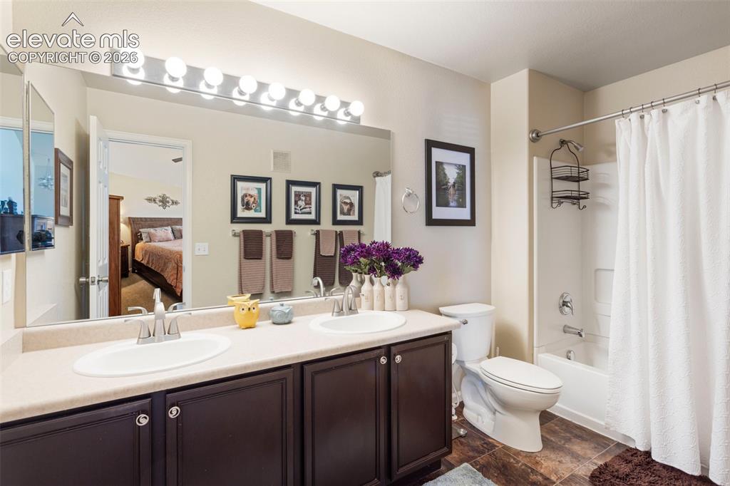 Image 16 of 26: The main floor powder room is located at the far end of the kitchen near th