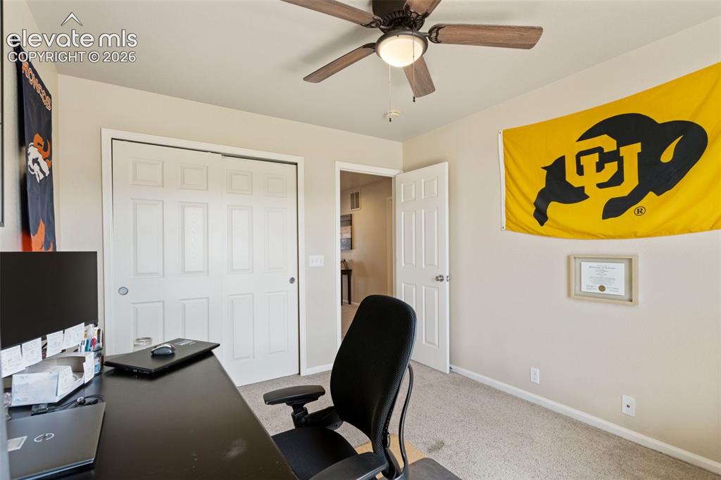 Image 20 of 26: Upper level bedroom 2 includes a ceiling fan for added comfort.