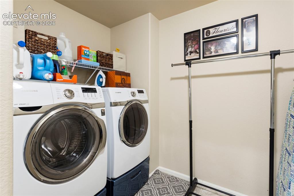 Image 22 of 26: Upper level bedroom 3 is currently used as an office. This room has a ceili